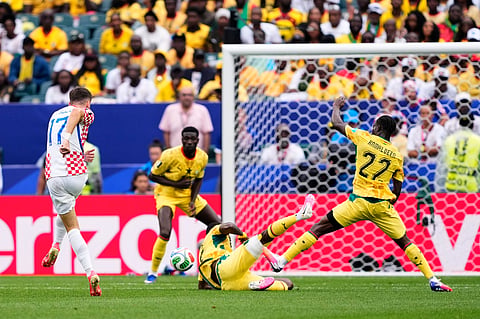 Croatia's Petar Sucic (17), left, tries a shot during the World Cup Group L soccer match between Croatia and Ghana in Philadelphia, Saturday, June 27, 2026.