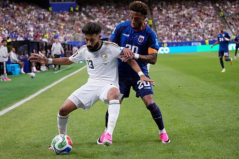 Saudi Arabia's Nawaf Bu Washl (13) keeps the ball away from Cape Verde's Ryan Mendes (20) during the first half of the World Cup Group H soccer match in Houston, Friday, June 26, 2026.