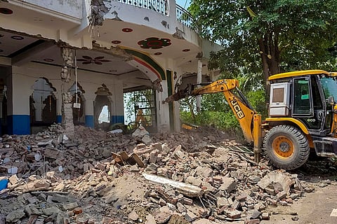 Administration carries out a demolition drive to remove illegal structures in the Tronica City, in Loni, Ghaziabad.