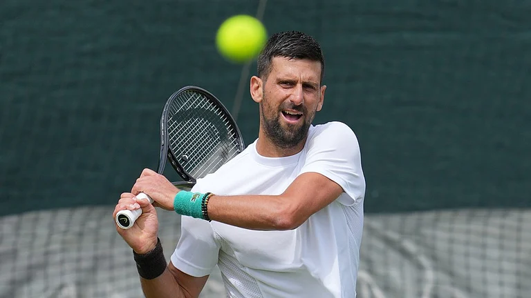 Novak Djokovic of Serbia practices one day ahead of the start of the Wimbledon Tennis Championships in London. - Kin Cheung/AP Photo
