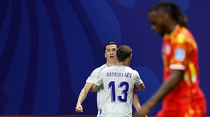 (AP Photo/Erik S. Lesser) : Uzbekistans Eldor Shomurodov (14) celebrates with teammate Sherzod Nasrullaev (13) after scoring their first goal during the World Cup Group K soccer match between DR Congo and Uzbekistan in Atlanta, Saturday, June 27, 2026.