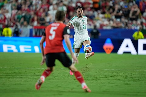 Algeria's Ramy Bensebaini (21) controls the ball during the World Cup Group J soccer match between Algeria and Austria in Kansas City, Mo., Saturday, June 27, 2026.