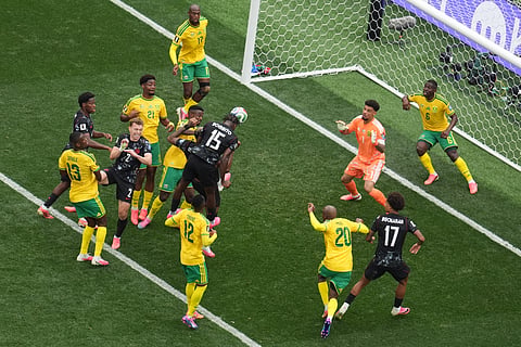 Canada's Moise Bombito, (15), makes an attempt to score against South Africa during the World Cup round of 32 soccer match in Inglewood, Calif
