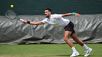 Kin Cheung/AP Photo : Novak Djokovic of Serbia practices one day ahead of the start of the Wimbledon Tennis Championships in London.