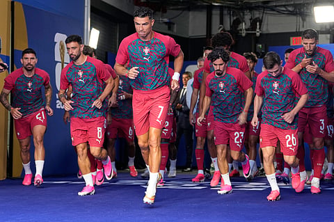 Portugal's Cristiano Ronaldo (7) leads the players onto the field to warm up ahead of the World Cup Group K soccer match between Colombia and Portugal in Miami Gardens 