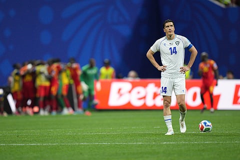 Uzbekistan's Eldor Shomurodov (14) reacts as Congo celebrates their second goal during the World Cup Group K soccer match between DR Congo and Uzbekistan in Atlanta, Saturday, June 27, 2026