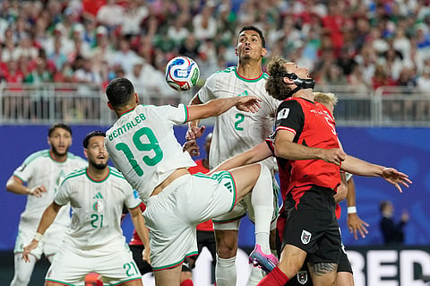 Algeria's Nabil Bentaleb (19) and Aissa Mandi (2) compete for the ball against Austria's Stefan Posch (5) during the World Cup Group J soccer match between Algeria and Austria in Kansas City, Mo., Saturday, June 27, 2026