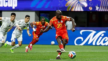 (AP Photo/Erik S. Lesser) : Congo's Yoane Wissa (20) kicks for a penalty kick goal during the World Cup Group K soccer match between DR Congo and Uzbekistan in Atlanta, Saturday, June 27, 2026.