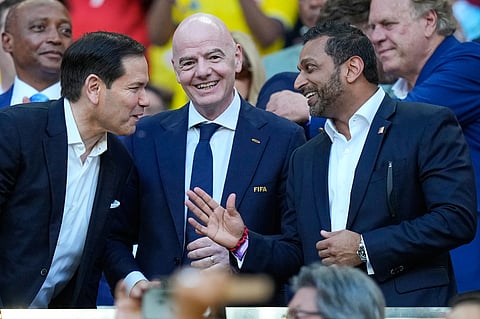 FIFA President Gianni Infantino, centre, stands with and United States Secretary of State Marco Rubio, left, and Director of the FBI, Kash Patel react ahead of the World Cup Group K soccer match between Colombia and Portugal in Miami Gardens