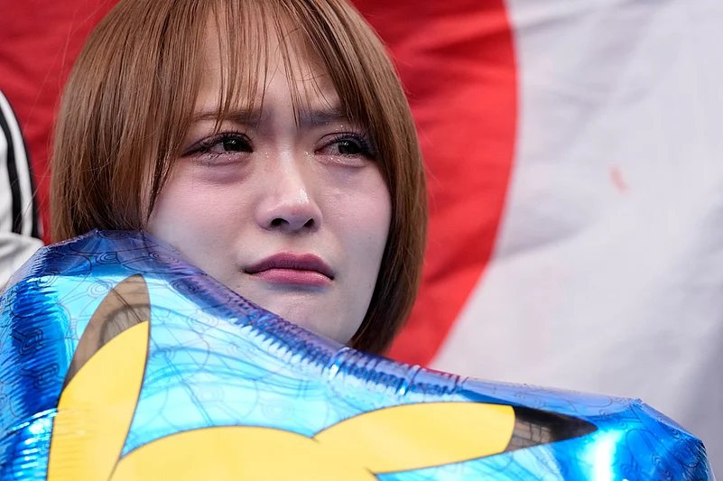 A Japan supporter reacts after the World Cup round of 32 soccer match between Brazil and Japan in Houston