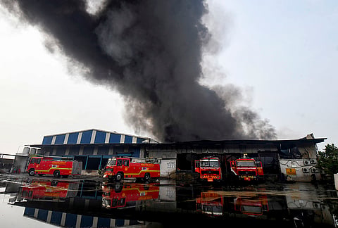 Dark smoke billows after a fire broke out at Dalda warehouse, in Patna.