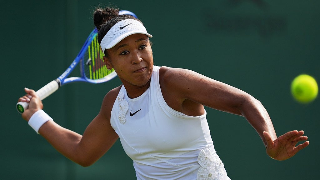 Naomi Osaka of Japan returns the ball to Elsa Jacquemot of France in their first round women's singles match at the Wimbledon Tennis Championships in London. - Maja Smiejkowska/AP Photo