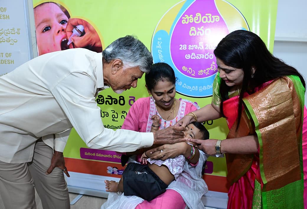 AP CM Chandrababu Naidu administering polio drops to an infant held by its mother