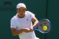 | Photo: AP/Kin Cheung : Shintaro Mochizuki of Japan returns the ball during the men's singles match at the Wimbledon Tennis Championships in London, Monday, June 29, 2026.