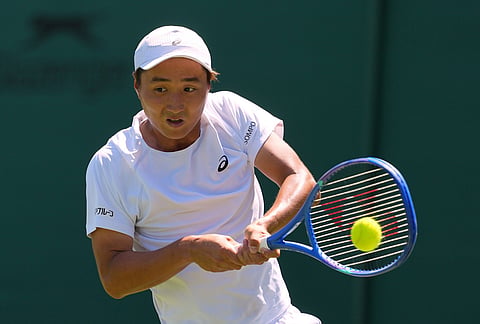 Shintaro Mochizuki of Japan returns the ball during the men's singles match at the Wimbledon Tennis Championships in London, Monday, June 29, 2026.