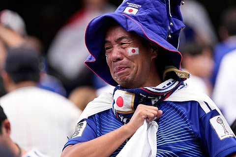 A Japan supporter reacts after the World Cup round of 32 soccer match between Brazil and Japan in Houston