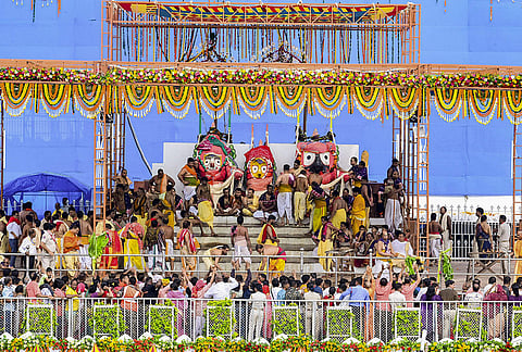 Devotees perform the preparatory rituals of Lord Jagannath, Lord Balabhadra and Goddess Subhadra during the ‘Snana Purnima’ festival, in Puri, Odisha.