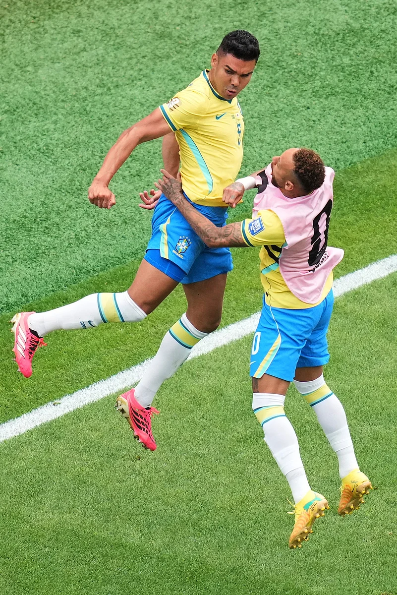Brazils Casemiro (5) celebrates with his teammate Brazils Neymar (10) after scoring his sides first goal during the World Cup round of 32 soccer match between Brazil and Japan in Houston