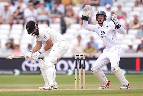 England's Jamie Smith, right, reacts as New Zealand's Daryl Mitchell is struck by the ball  on day four of the Third Test cricket match between England and New Zealand, in Nottingham, England, Sunday June 28, 2026. 