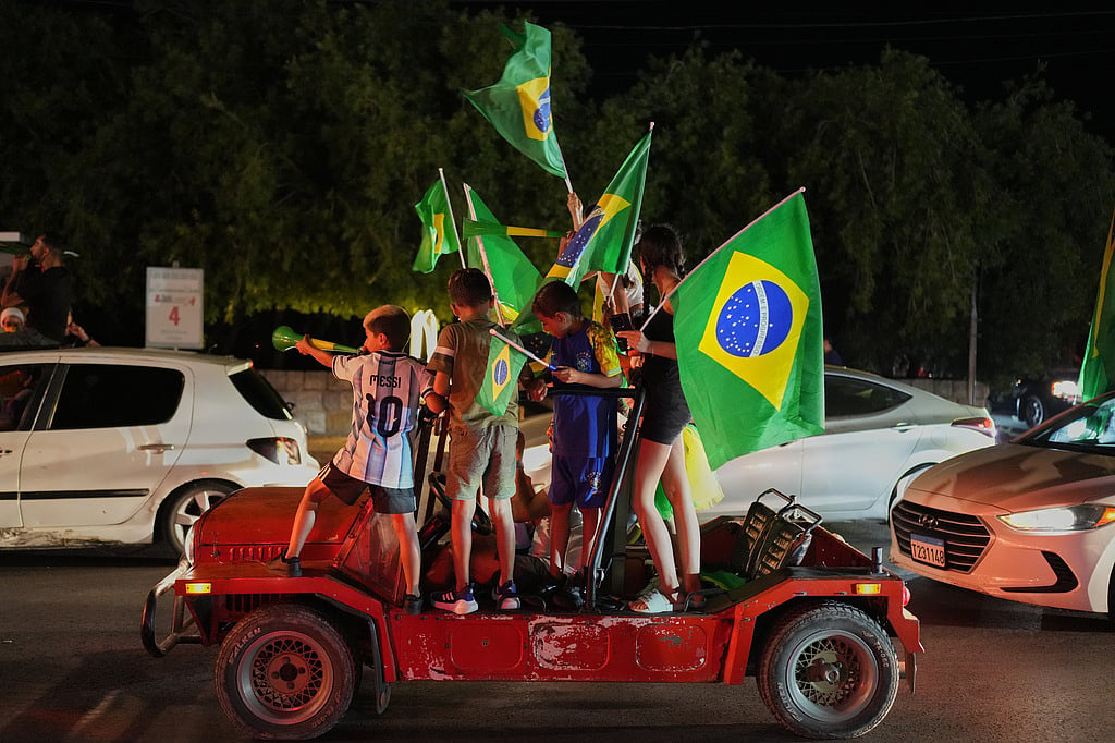 Supporters of Brazils national team celebrate, after Brazil defeated Japan in a Round of 32 soccer match at the FIFA World Cup, in Zgharta, northern Lebanon