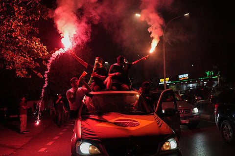 Supporters of Brazil's national soccer team celebrate after Brazil defeated Japan in a Round of 32 soccer match at the FIFA World Cup, in Zgharta, northern Lebanon