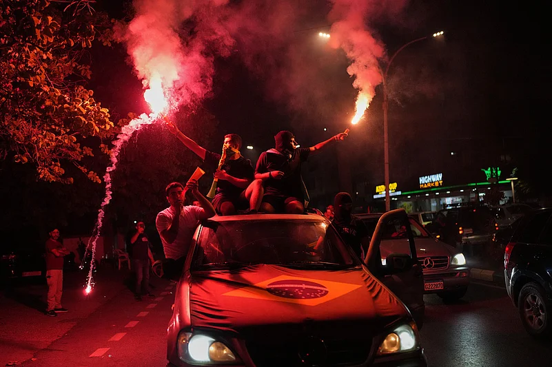 Supporters of Brazils national soccer team celebrate after Brazil defeated Japan in a Round of 32 soccer match at the FIFA World Cup, in Zgharta, northern Lebanon
