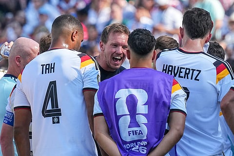 Germany head coach Julian Nagelsmann talks with his players at the hydration break during the World Cup round of 32 soccer match between Germany and Paraguay in Foxborough