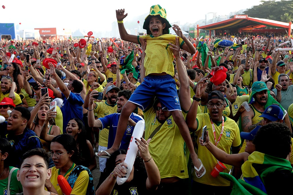 Brazil fans celebrate after Brazil defeated Japan at a World Cup soccer match as they watch a live broadcast of the game on Copacabana Beach in Rio de Janeiro