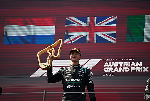 Mercedes driver George Russell of Britain stands on the podium after winning the Austrian F1 Grand Prix, in Spielberg, Austria, Sunday, June 28, 2026.