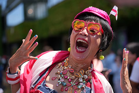 A tennis supporter cheers during the first day of the Wimbledon Tennis Championships in London, Monday, June 29, 2026.