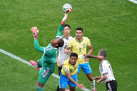 Japan goalkeeper Zion Suzuki (1) clears the ball during the World Cup round of 32 soccer match between Brazil and Japan in Houston