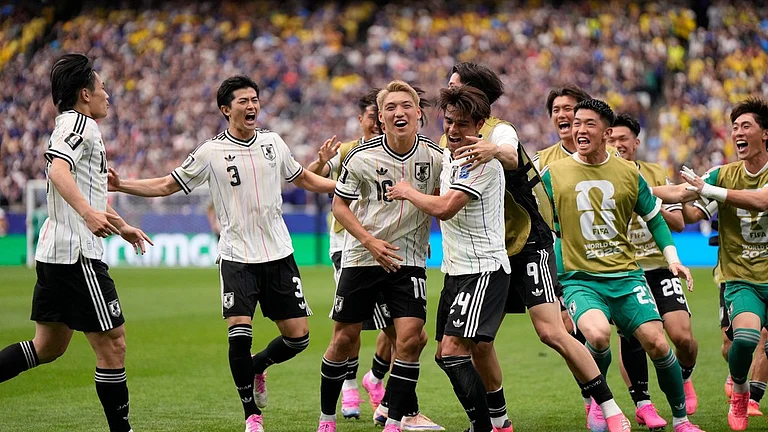 Japan's Kaishu Sano (24) celebrates with teammates after scoring the opening goal of his team during the World Cup round of 32 soccer match between Brazil and Japan in Houston - AP Photo/Ashley Landis