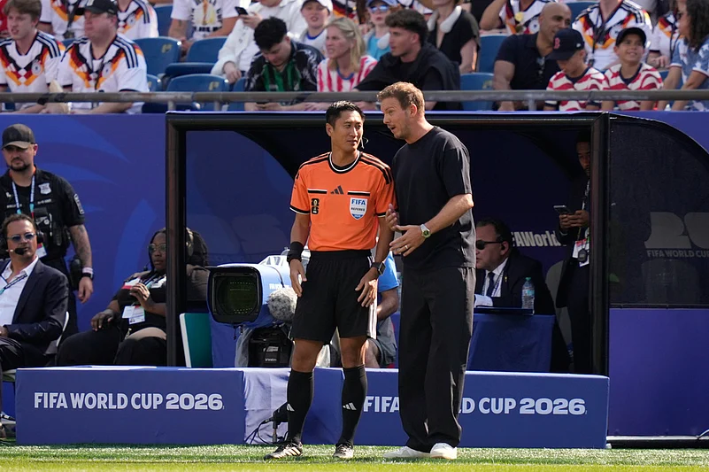 Germany head coach Julian Nagelsmann speaks to fourth official Ma Ning, of China, during the World Cup round of 32 soccer match between Germany and Paraguay in Foxboroug