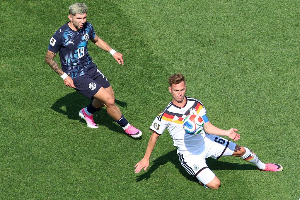 Germanys Joshua Kimmich (6) challenges for the ball with Paraguays Julio Enciso (19) during the World Cup round of 32 soccer match between Germany and Paraguay in Foxborough