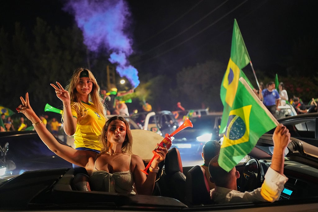Supporters of Brazils national team celebrate after Brazil defeated Japan in a Round of 32 soccer match at the FIFA World Cup, in Zgharta, northern Lebanon