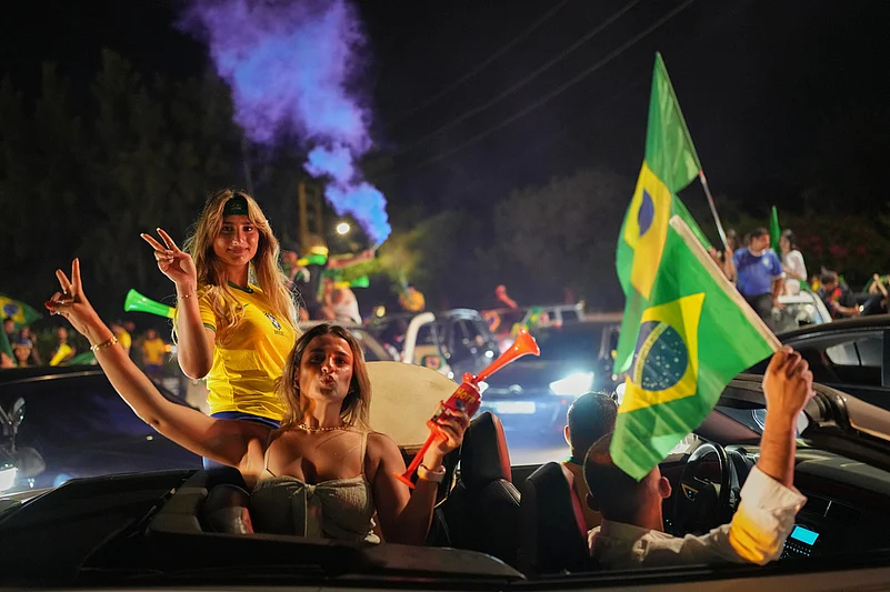 Supporters of Brazils national team celebrate after Brazil defeated Japan in a Round of 32 soccer match at the FIFA World Cup, in Zgharta, northern Lebanon