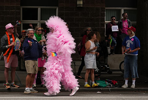 A person calling themselves "Seattle Cloud Guy" jogs by during the Pride Parade, Sunday, June 28, 2026, in Seattle. 