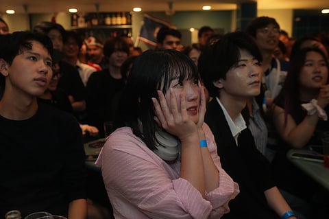 Fans for the Japan team react to a play in the second half of the round of 32 FIFA World Cup soccer game between Brazil and Japan being held in Texas, as they gather for a watch party in Tokyo