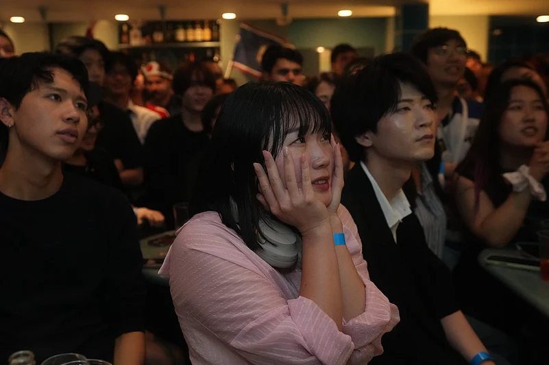 Fans for the Japan team react to a play in the second half of the round of 32 FIFA World Cup soccer game between Brazil and Japan being held in Texas, as they gather for a watch party in Tokyo