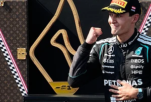| Photo: AP/Darko Bandic : Mercedes driver George Russell of Britain celebrates on the podium after winning the Austrian F1 Grand Prix, in Spielberg, Austria, Sunday, June 28, 2026.