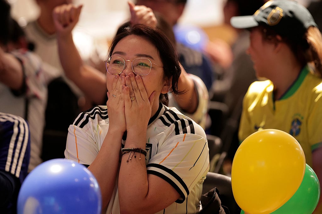 A Japan fan reacts after Brazil scored the equalizer during a World Cup soccer match between Brazil and Japan in the Liberdade district of Sao Paulo