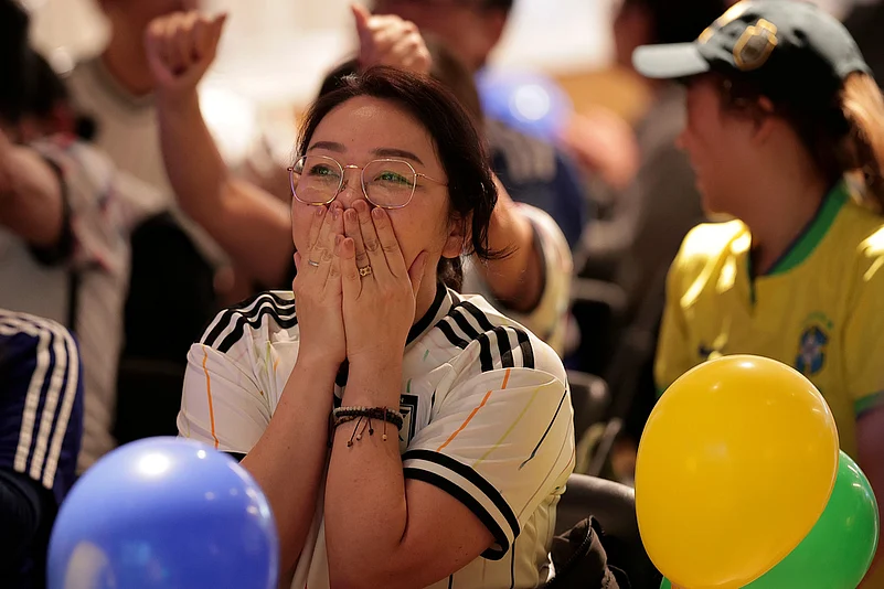 A Japan fan reacts after Brazil scored the equalizer during a World Cup soccer match between Brazil and Japan in the Liberdade district of Sao Paulo