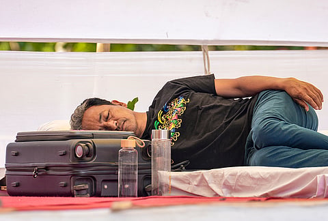 Activist Sonam Wangchuk rests during an indefinite hunger strike at the Jantar Mantar protest by the Cockroach Janata Party to press for Education Minister Dharmendra Pradh's resignation over alleged exam irregularities, in New Delhi.