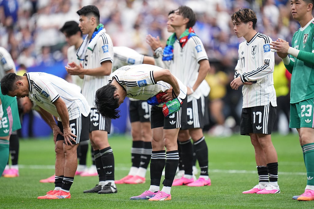 Japan players bow after the World Cup round of 32 soccer match between Brazil and Japan in Houston