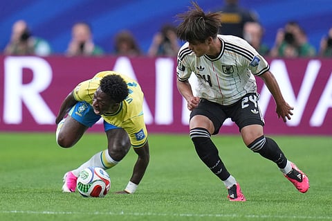 Brazil's Vinicius Junior (7) reacts after a foul by Japan's Kaishu Sano (24) during the World Cup round of 32 soccer match between Brazil and Japan in Houston