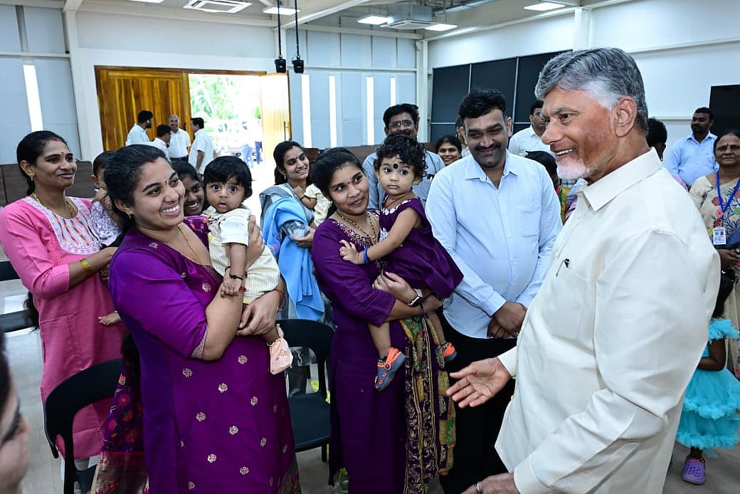 AP CM Chandrababu Naidu smiling and speaking with women and children at the event