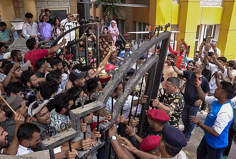Protesters clash with security personnel at the gate of the Regional Hospital during a demonstration over the death of a woman after childbirth, in Kullu, Himachal Pradesh, Monday, June 29, 2026. Protesters demanded action against the hospital administration and the state government over the incident. 