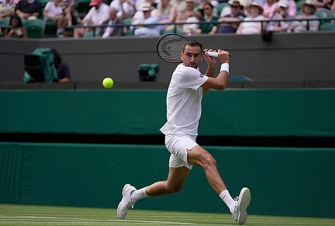 Marin Cilic of Croatia returns the ball to Daniil Medvedev of Russia in their first round men's singles match at the Wimbledon Tennis Championships in London, Monday, June 29, 2026.