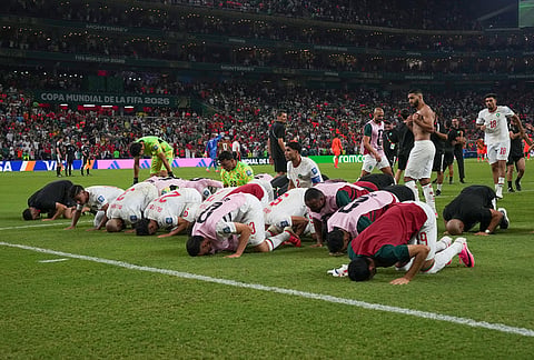 Morocco prays to celebrate a win during the World Cup round of 32 soccer match between the Netherlands and Morocco in Guadalupe, near Monterrey, Mexico.