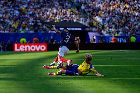Sweden's Lucas Bergvall (7) tackles France's Lucas Digne (3) during the World Cup round of 32 soccer match